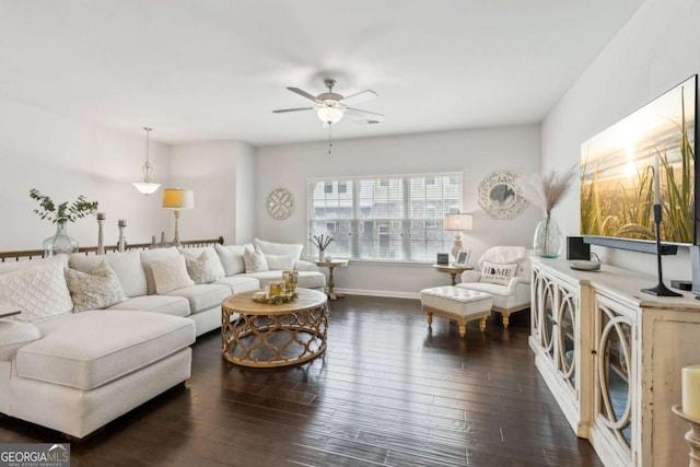 living room with a ceiling fan, dark wood-type flooring, and baseboards