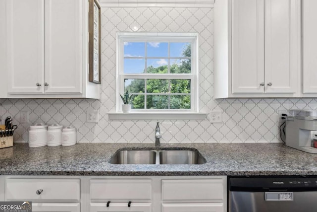 kitchen with dishwasher, a sink, white cabinetry, and healthy amount of natural light