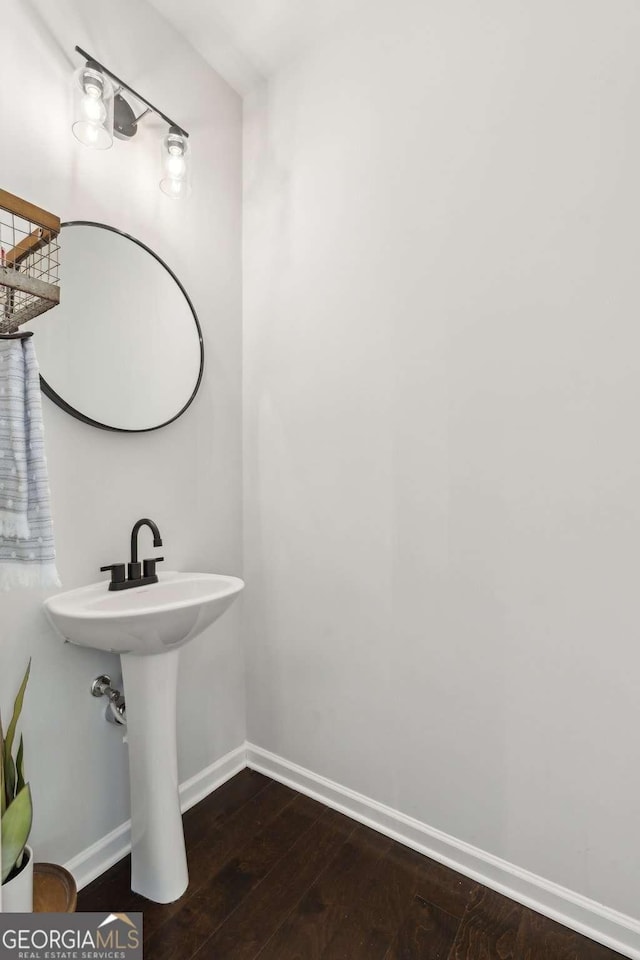 bathroom with hardwood / wood-style floors and baseboards