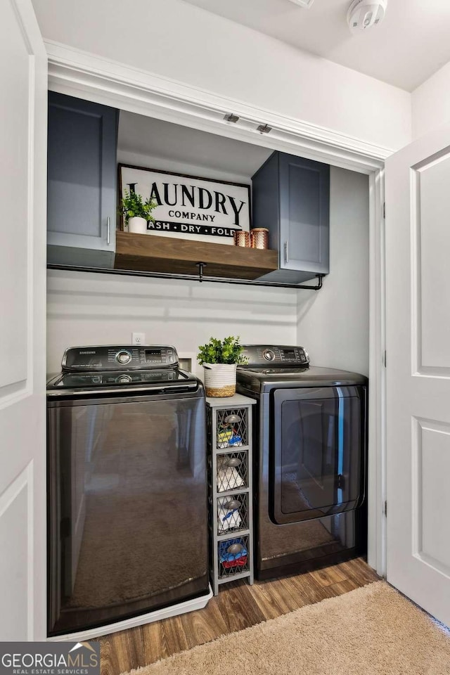 bar featuring washer and dryer and wood finished floors