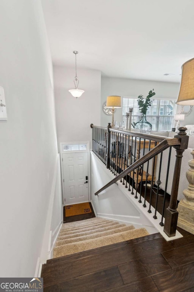 stairway with wood finished floors