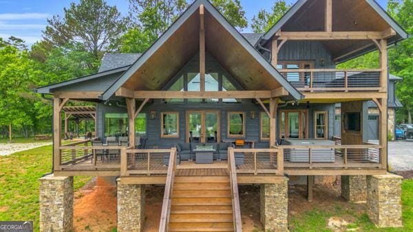 245 Chat-A-While Ln, Morganton, GA 30560 - rear view of house featuring stairway, an outdoor living space, a deck, a balcony, and board and batten siding