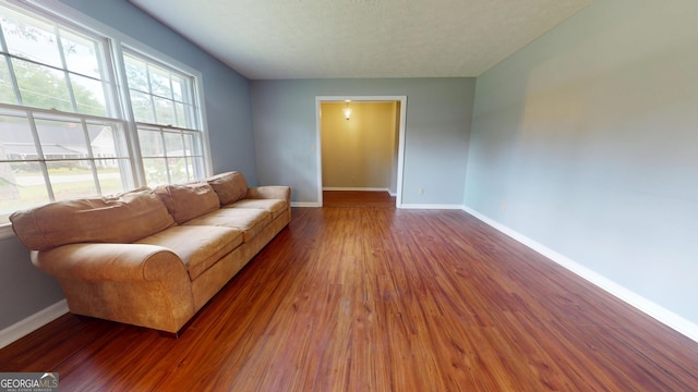 304 5th Ave, Twin City, GA 30471 - living room featuring baseboards and wood finished floors