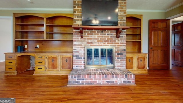 304 5th Ave, Twin City, GA 30471 - unfurnished living room with wood finished floors, crown molding, a brick fireplace, and a textured ceiling