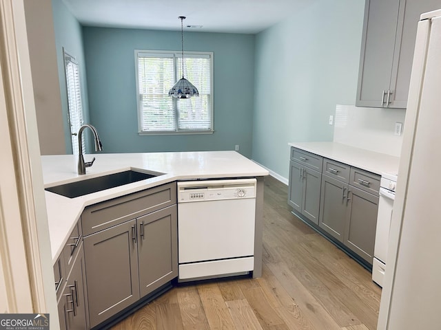 6605 New Ridge Ct, Cumming, GA 30041 - kitchen featuring white appliances, a sink, gray cabinetry, and light wood-type flooring