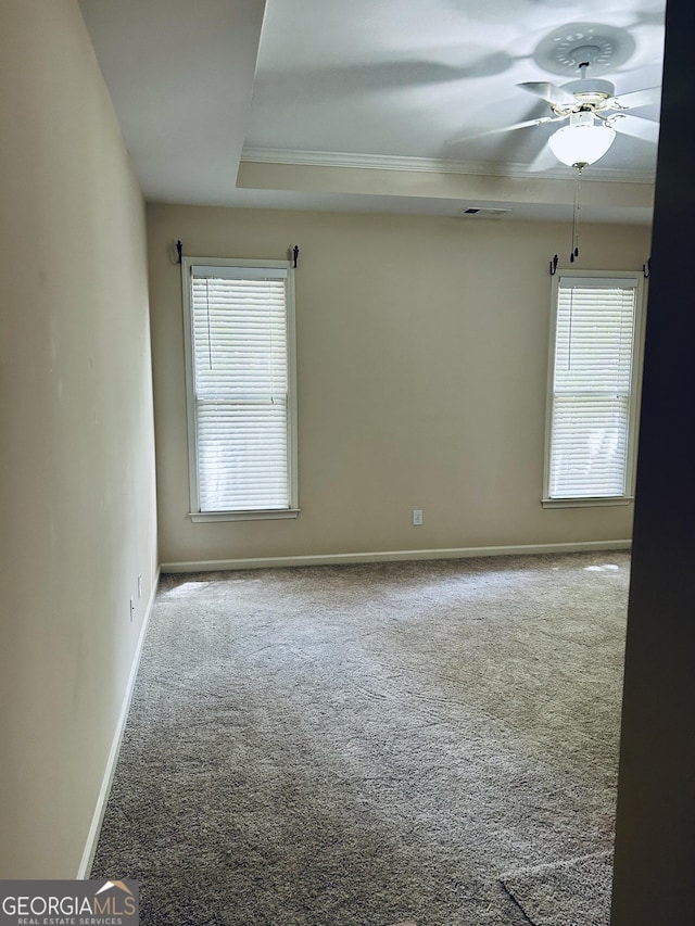 6605 New Ridge Ct, Cumming, GA 30041 - carpeted empty room featuring healthy amount of natural light, baseboards, a ceiling fan, ornamental molding, and a tray ceiling
