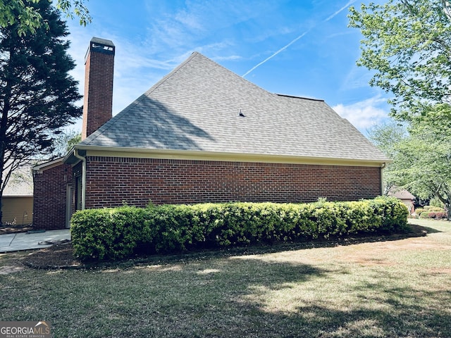 6605 New Ridge Ct, Cumming, GA 30041 - view of property exterior featuring a chimney, a yard, brick siding, and a shingled roof