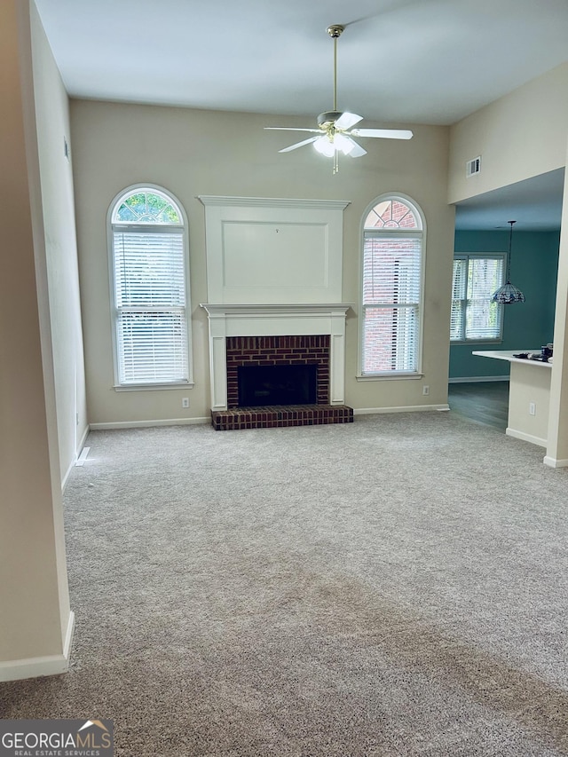 6605 New Ridge Ct, Cumming, GA 30041 - unfurnished living room with ceiling fan, a brick fireplace, carpet, and baseboards