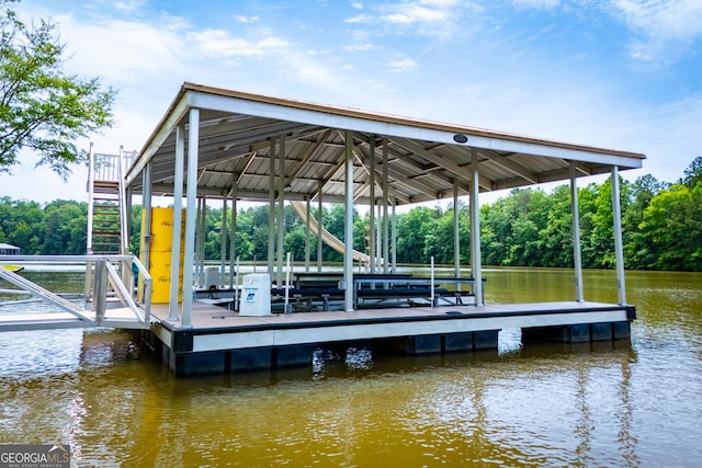 dock area with a water view and view of wooded area