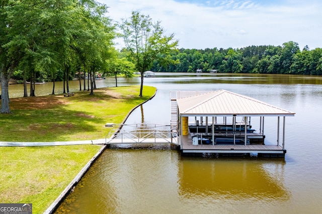 dock area featuring a water view, boat lift, and a yard