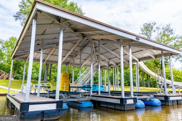 dock area with boat lift, a water view, and stairway