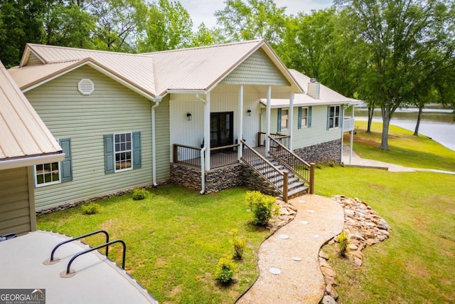 view of front of home with a front yard, a porch, and stairs