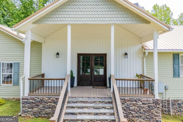 doorway to property featuring covered porch and french doors