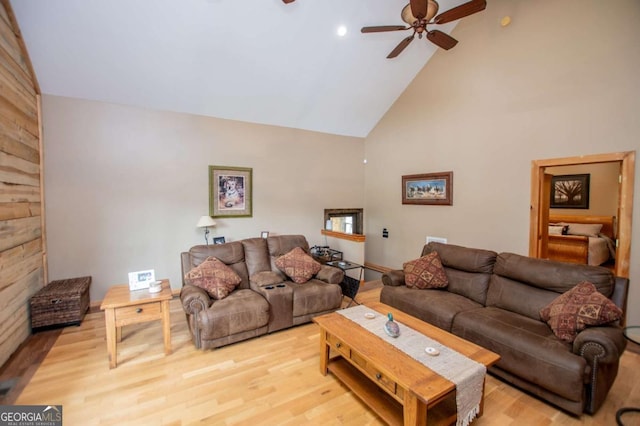 living room featuring high vaulted ceiling, ceiling fan, and wood finished floors