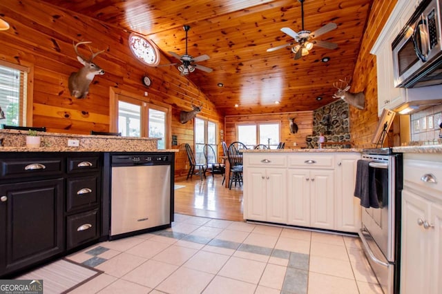 kitchen with appliances with stainless steel finishes, a ceiling fan, white cabinets, wooden ceiling, and dark cabinetry