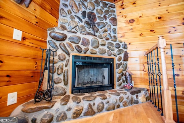 detailed view of a stone fireplace and wood finished floors