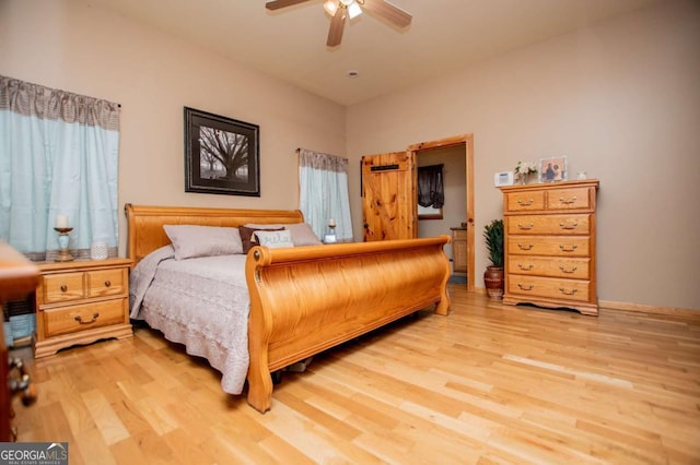 bedroom with light wood-style flooring and a ceiling fan