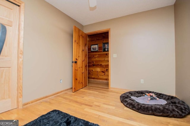 bedroom with wood finished floors, baseboards, and a ceiling fan