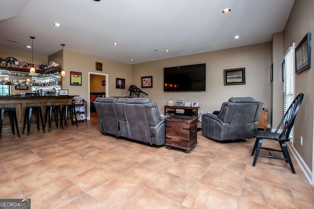 living area featuring recessed lighting, bar area, and light tile patterned floors