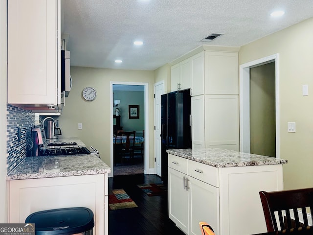 6940 Treeline Dr, Cumming, GA 30028 - kitchen with dark wood-style floors, recessed lighting, tasteful backsplash, white cabinets, and a textured ceiling