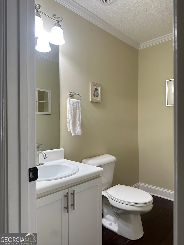 6940 Treeline Dr, Cumming, GA 30028 - bathroom featuring toilet, vanity, ornamental molding, a textured ceiling, and baseboards