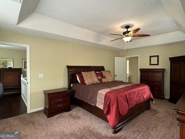 6940 Treeline Dr, Cumming, GA 30028 - carpeted bedroom featuring a tray ceiling, a textured ceiling, baseboards, and a ceiling fan