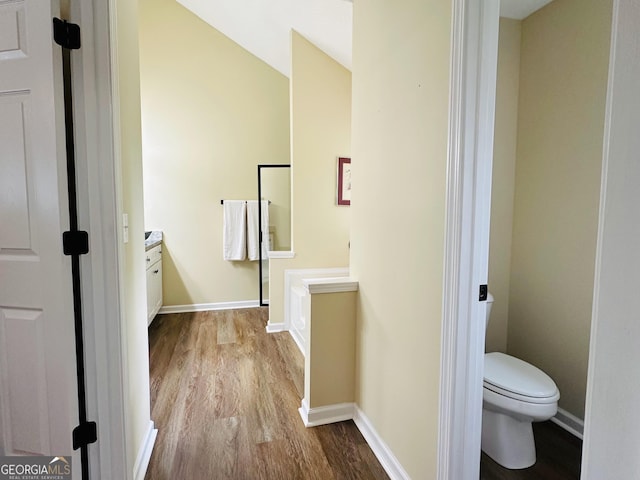 6940 Treeline Dr, Cumming, GA 30028 - bathroom with wood finished floors, toilet, baseboards, and vanity