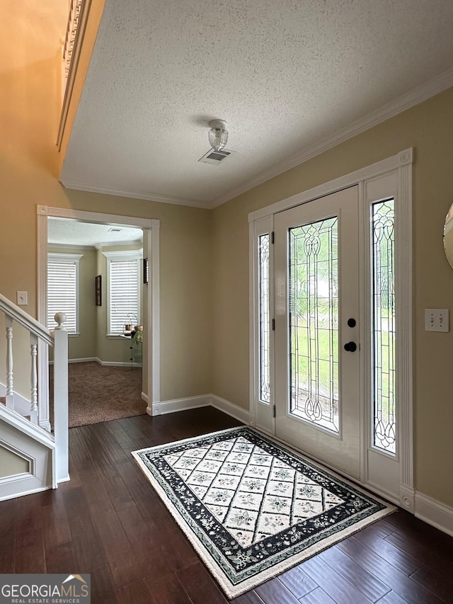 6940 Treeline Dr, Cumming, GA 30028 - foyer featuring a textured ceiling, baseboards, crown molding, dark wood-type flooring, and stairway