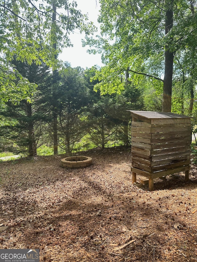 6940 Treeline Dr, Cumming, GA 30028 - view of yard featuring a fire pit