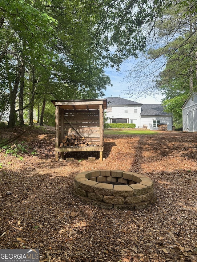 6940 Treeline Dr, Cumming, GA 30028 - view of yard with a fire pit and an outbuilding