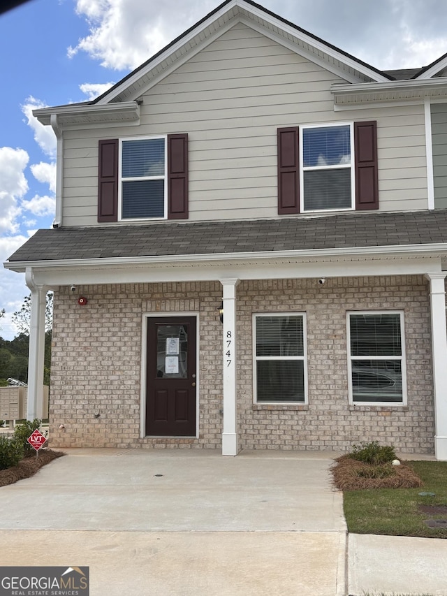 8747 Lakeview Commons Lot 1, Jonesboro, GA 30238 - view of front of home with a porch and roof with shingles