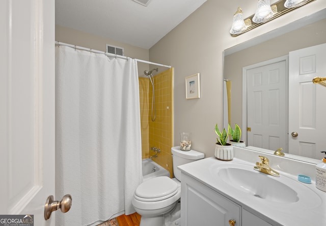 full bath with toilet, vanity, and shower / tub combo