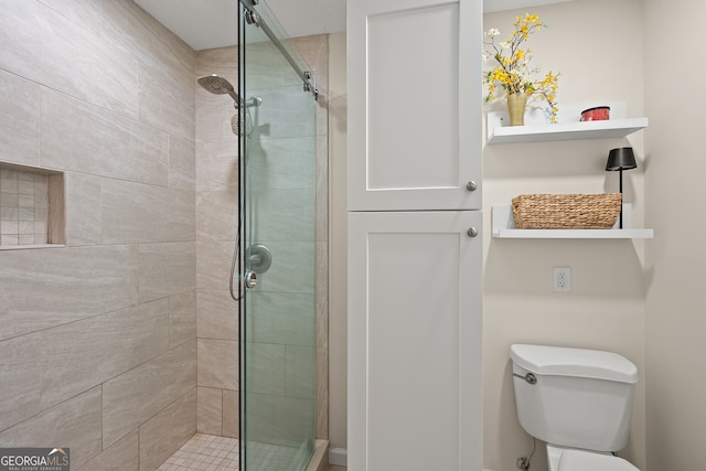 bathroom with a stall shower and toilet