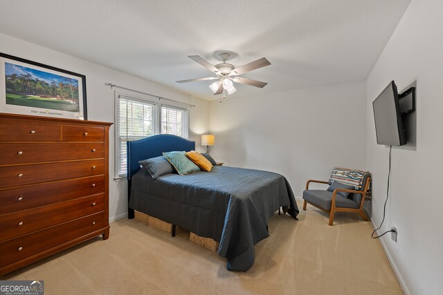 bedroom with light carpet, baseboards, and ceiling fan