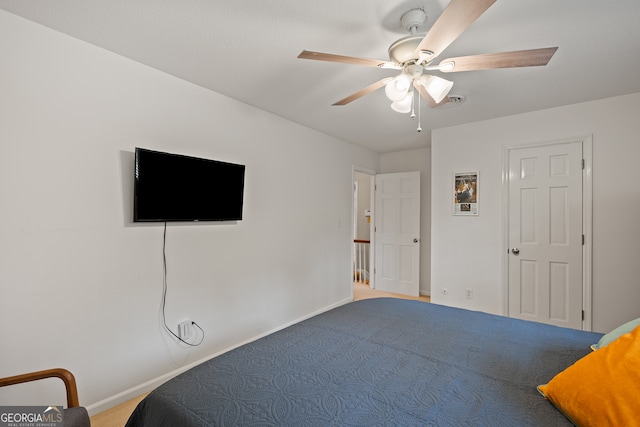 carpeted bedroom featuring baseboards and ceiling fan