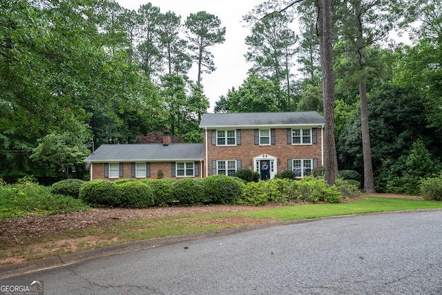 colonial home with brick siding