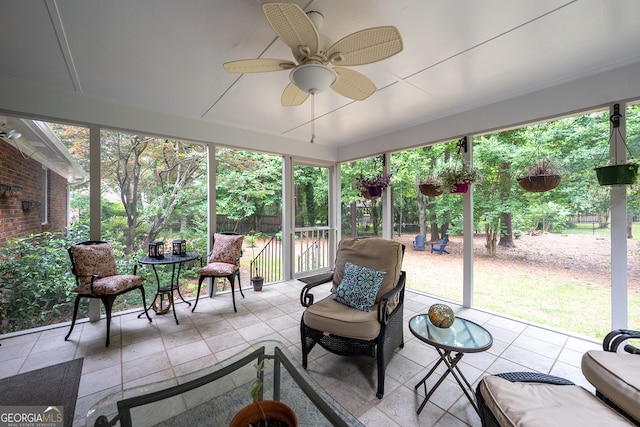 sunroom / solarium featuring ceiling fan
