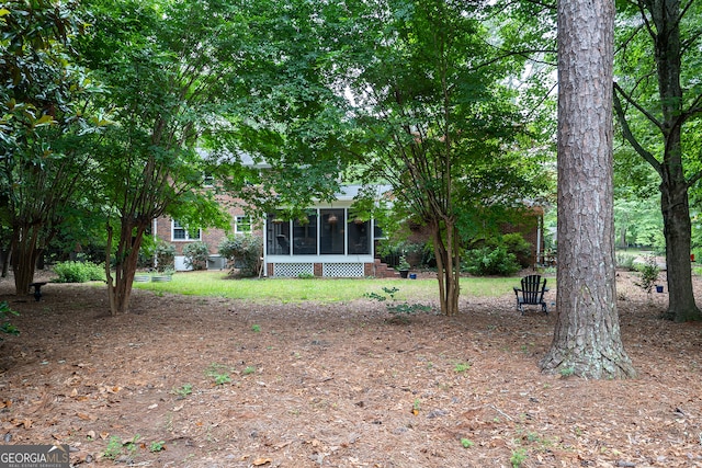 view of yard featuring a sunroom