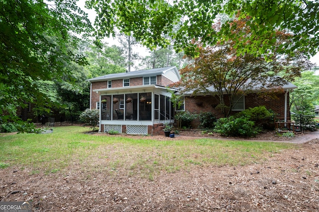 back of house featuring a sunroom and brick siding