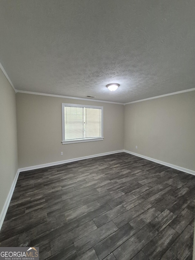 spare room with dark wood-style floors, crown molding, and baseboards