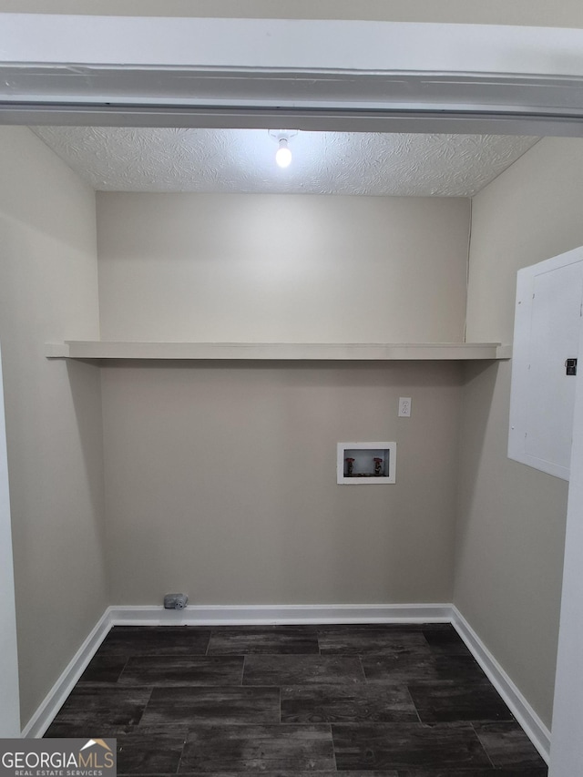 laundry room featuring washer hookup, baseboards, dark wood finished floors, and electric panel