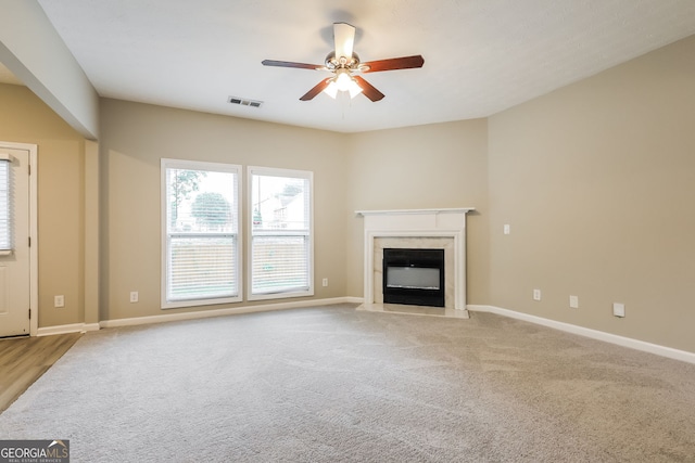 11576 Kades Trl, Hampton, GA 30228 - unfurnished living room with ceiling fan, a high end fireplace, baseboards, and carpet