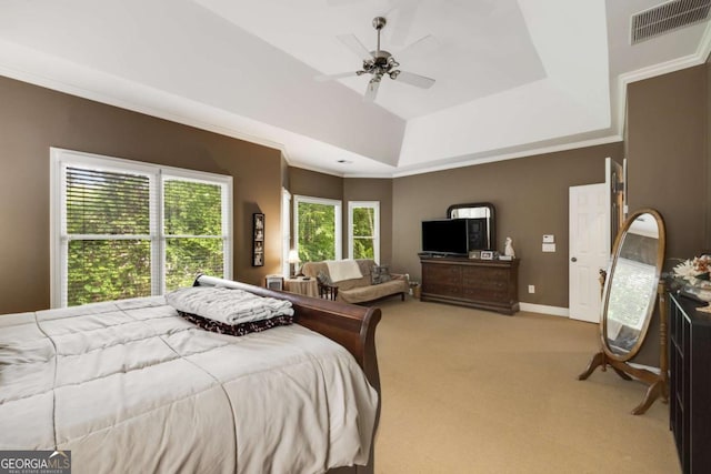 carpeted bedroom with a raised ceiling, ornamental molding, baseboards, and ceiling fan