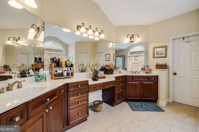 bathroom with vaulted ceiling, tile patterned floors, and vanity