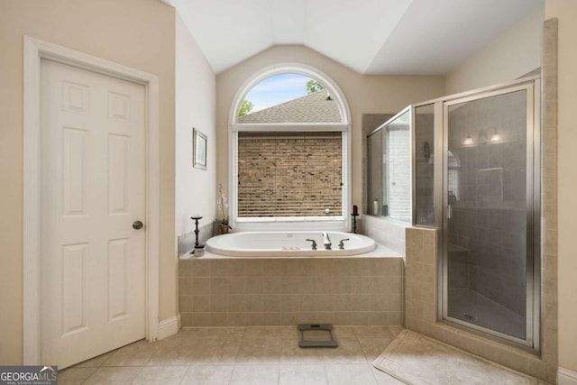 bathroom featuring tile patterned flooring, a stall shower, lofted ceiling, and a bath