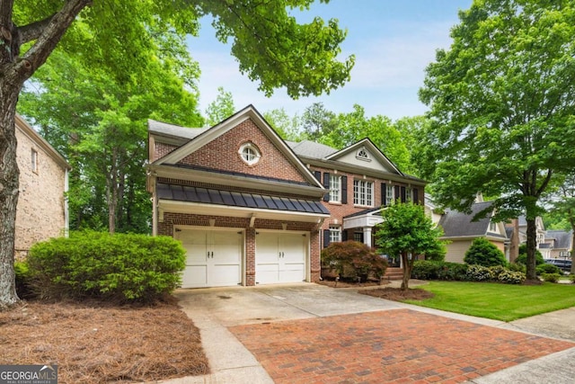 view of front facade featuring brick siding, driveway, a standing seam roof, metal roof, and a front yard