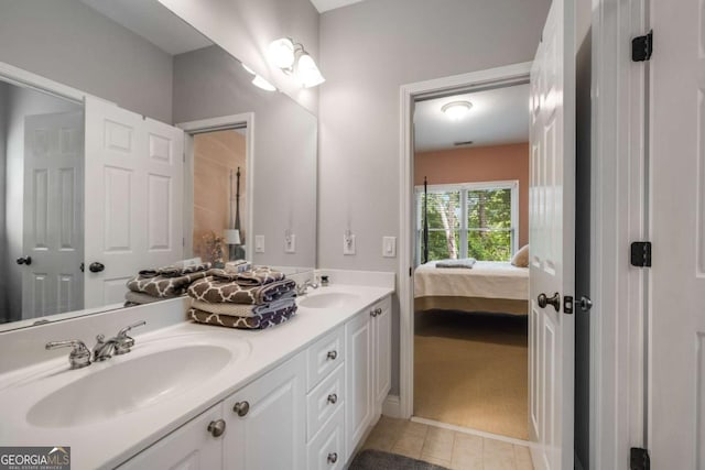 full bath with double vanity, tile patterned floors, and ensuite bathroom