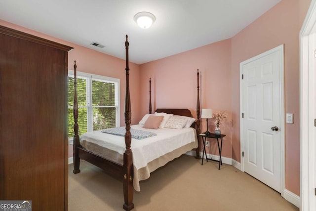 bedroom with light carpet and baseboards