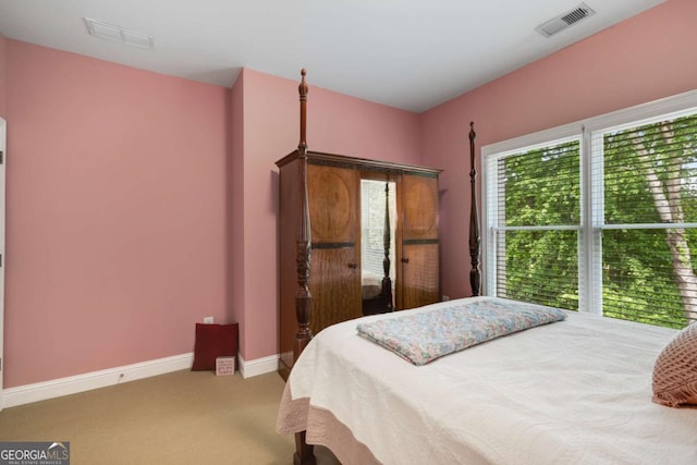 bedroom with carpet flooring, multiple windows, and baseboards