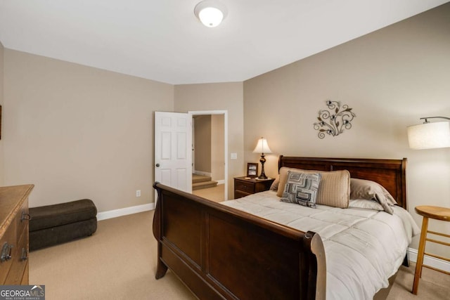 bedroom with light carpet and baseboards